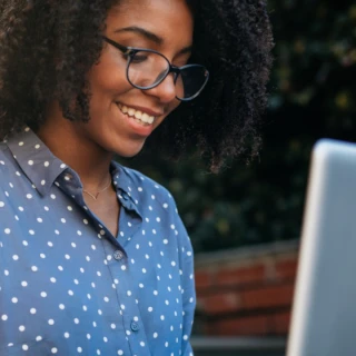 Smiling lady looking at a laptop screen